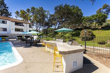 A patio with a bar and a swimming pool